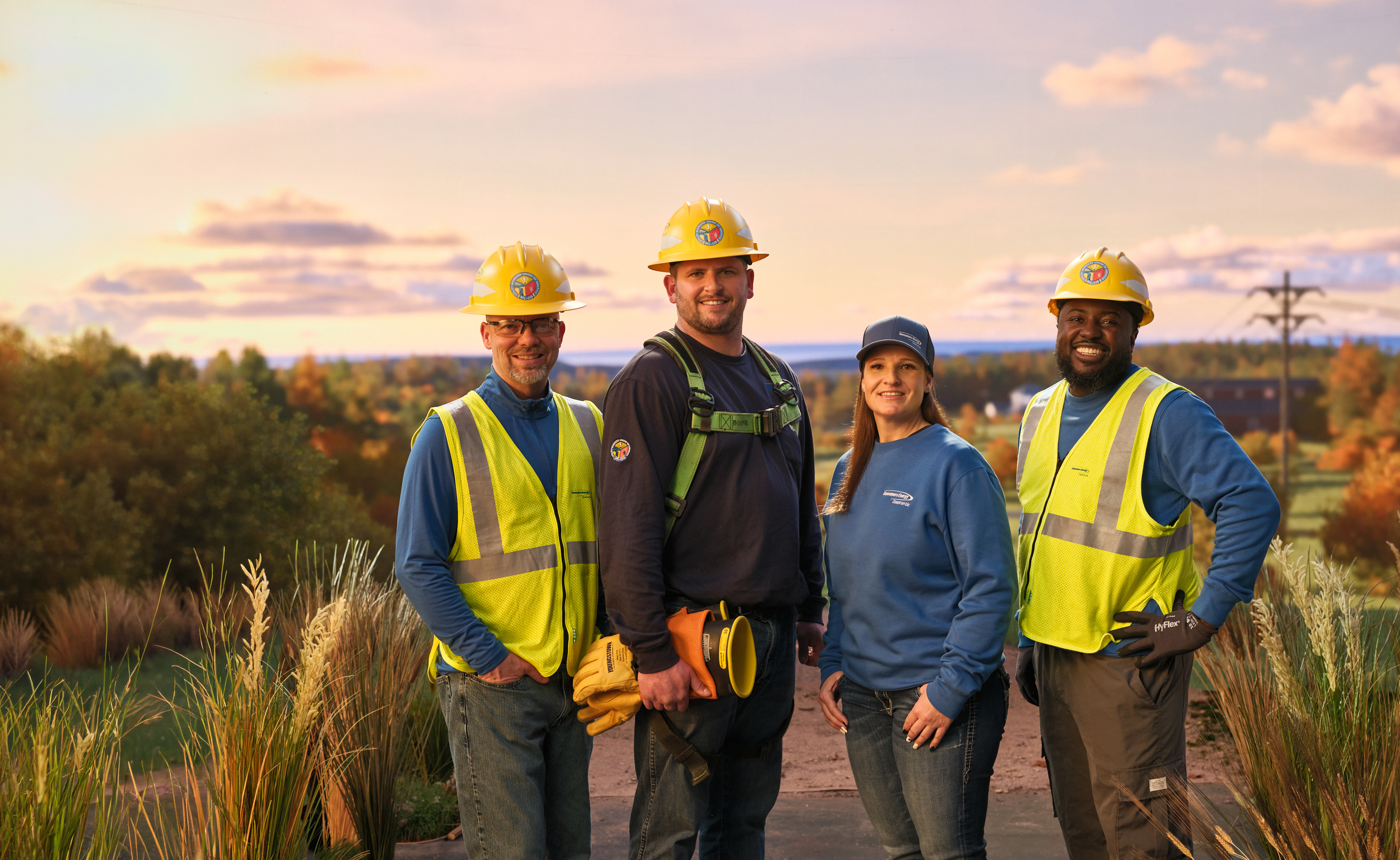 line workers smiling at sunset